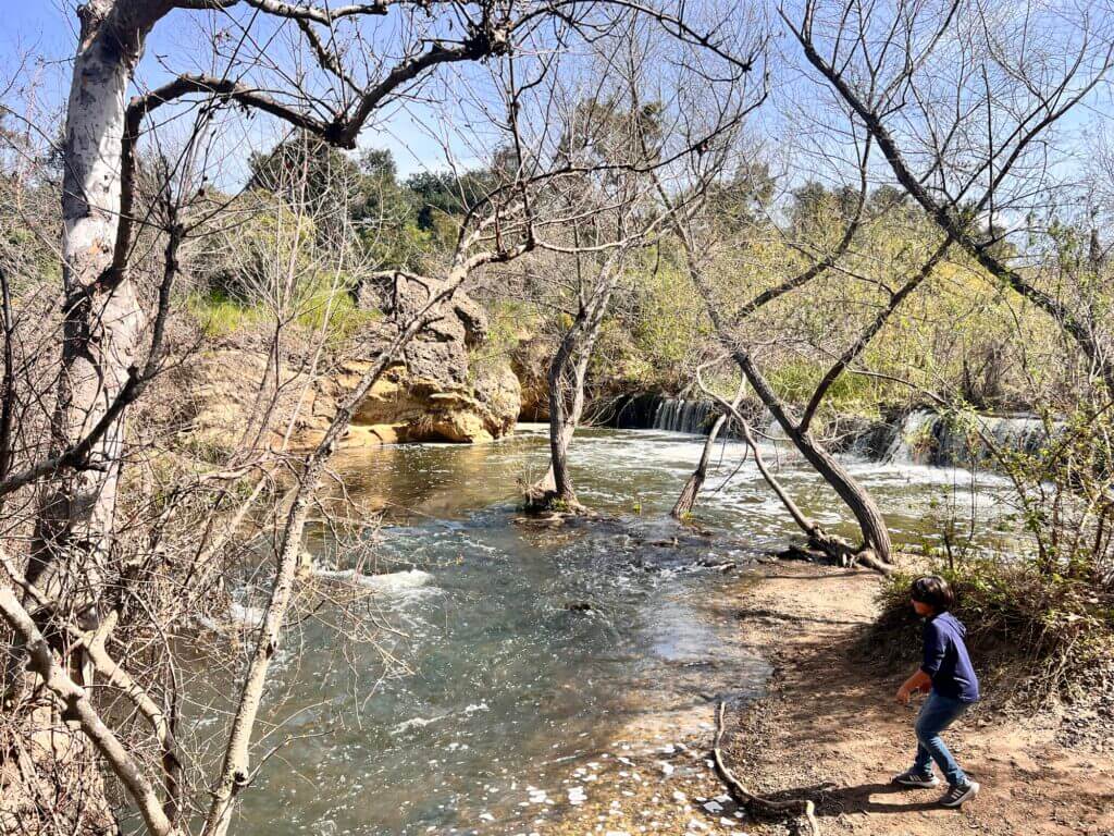 Boy next to river
