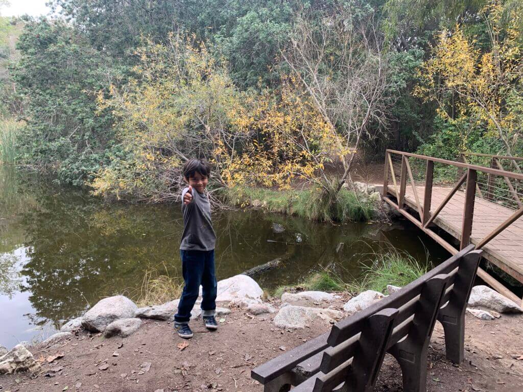 Boy next to lake